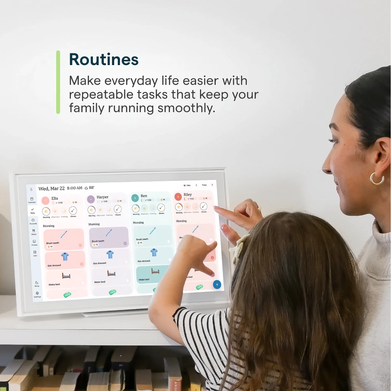 Woman and child interacting with a digital display showing daily routines.